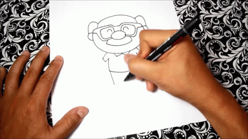 two hands with blue paint draw a cartoon character
