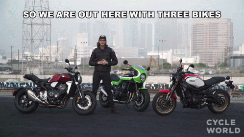 a man standing next to three different motorcycles