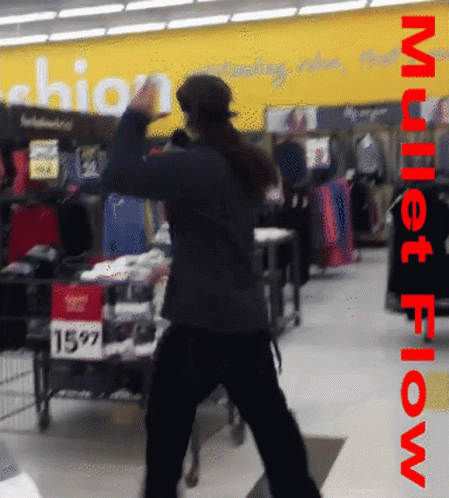 a man walking past an empty shopping cart at a store