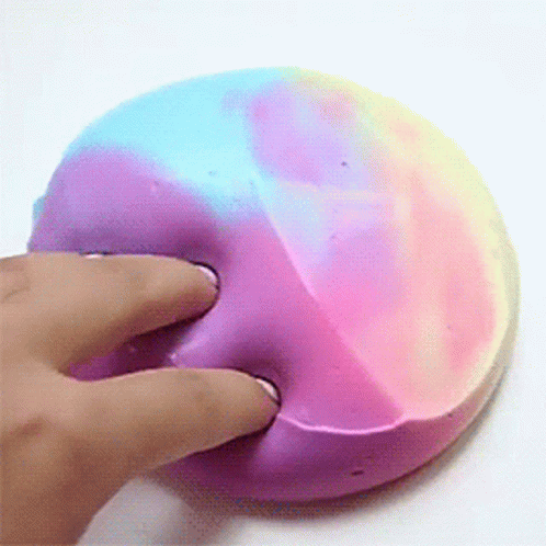 a person touching a colorful object on a white surface