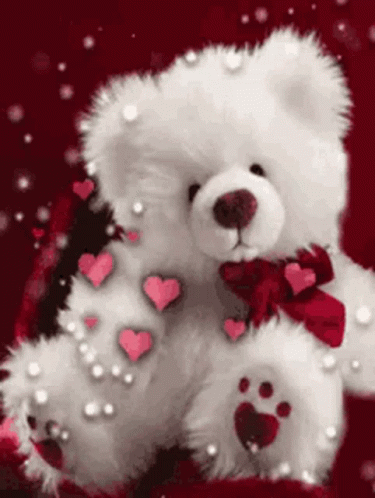 a white teddy bear with hearts in it
