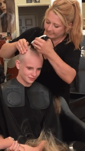 a woman getting a haircut for her brother