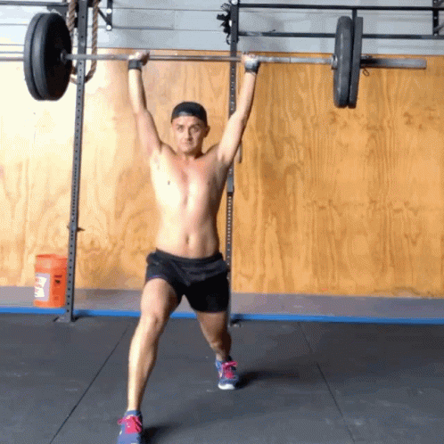 shirtless guy doing exercise at the gym with barbell