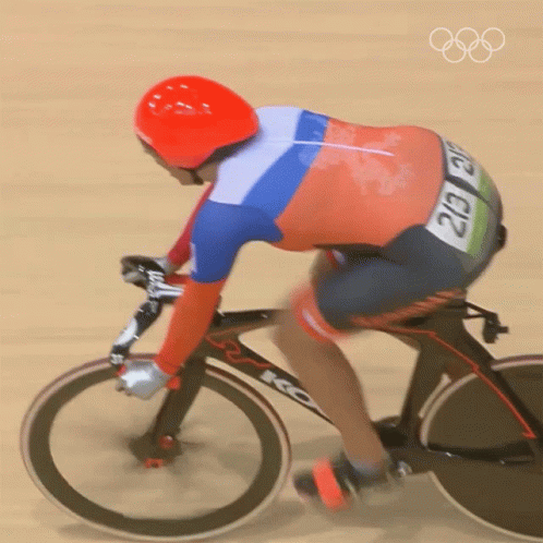 the figure is riding a triathlon bike on track