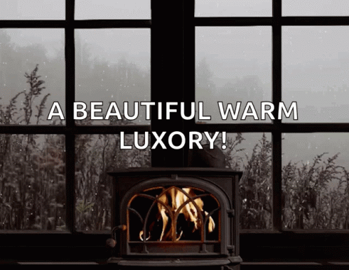 a window with a wooden stove near it that says a beautiful warm luxury