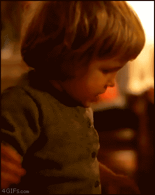 a little boy in black shirt with blue highlights on his face