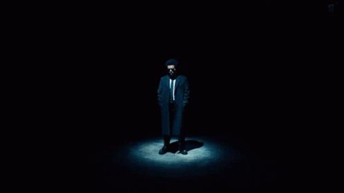 a man in a suit in the dark