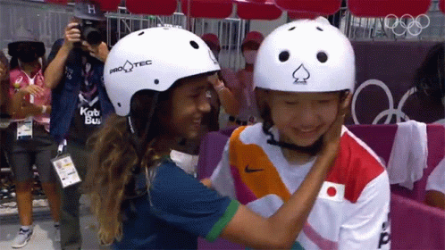 a boy and girl wearing helmets are taking a po