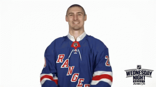 a man is wearing a red and blue hockey jersey