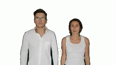 a man and woman wearing white clothing stand next to each other