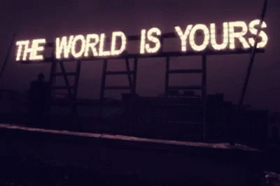 there is a neon sign saying the world is yours