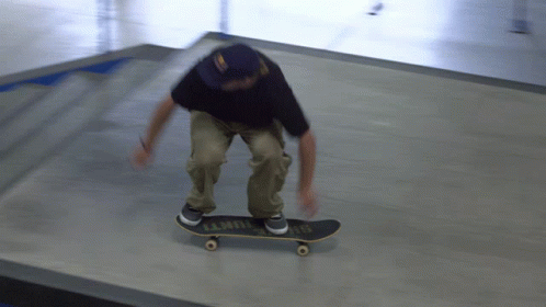 a skate boarder going around an area in a room