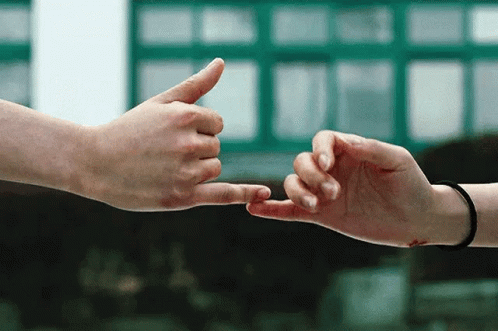 two people reaching out to touch one another's hand
