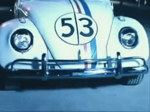 an old fashioned car with the number 53 painted on it