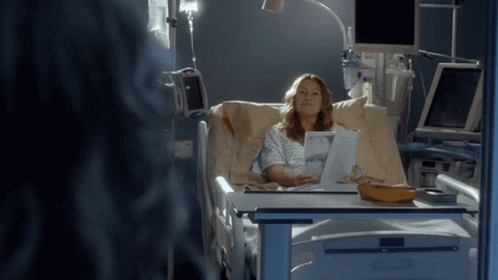 an image of a woman in hospital setting on laptop