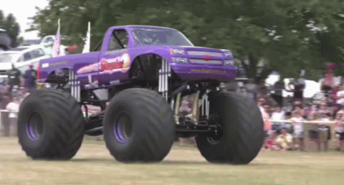 there is an extreme monster truck going down the street
