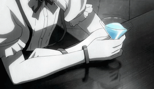 a person holding a glass and drinking some drink