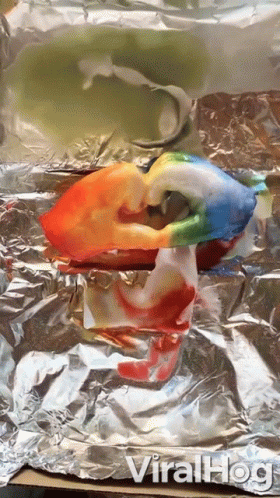 a glass bird is sitting on top of aluminum foil