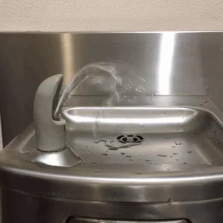 a sink made of steel with water running from it