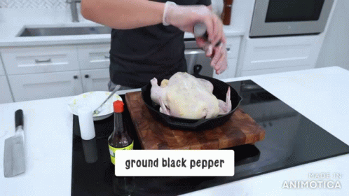 a man in purple gloves is preparing a dish