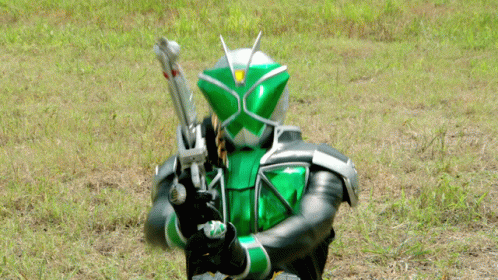 a woman in a green costume and holding some guns
