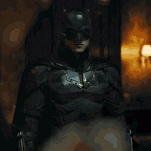 the batman is sitting in the chair by himself
