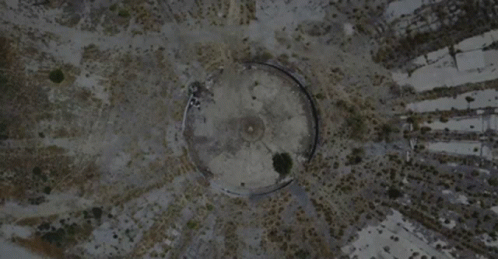a bird's eye view of a building surrounded by dirt