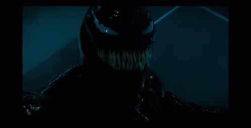 the image shows a dark skinned creature with fangs