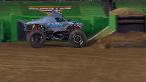 a monster truck moving along a track during an event