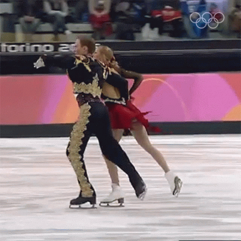 two figure skaters performing in front of an audience