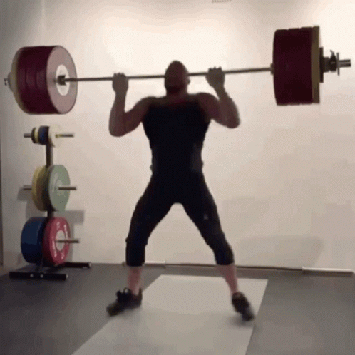 the man is holding on to a heavy barbell