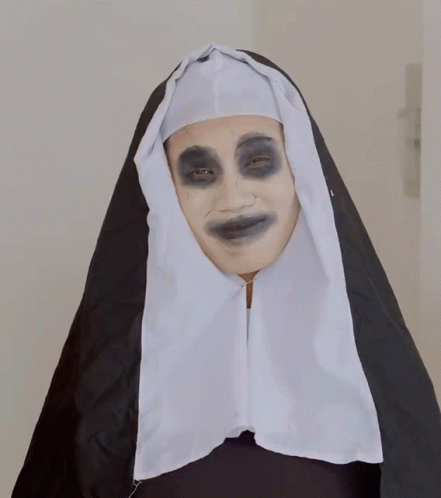 a nun's face is wearing blue and a black cape