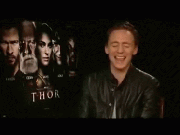 man smiling at camera in front of dark po with the title'thor '