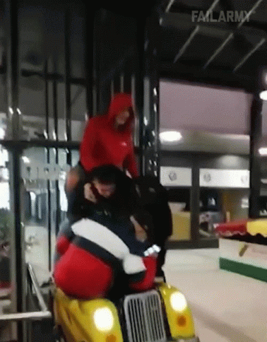 a man riding on the back of a motorcycle in an indoor area