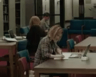 people in a liry studying and working
