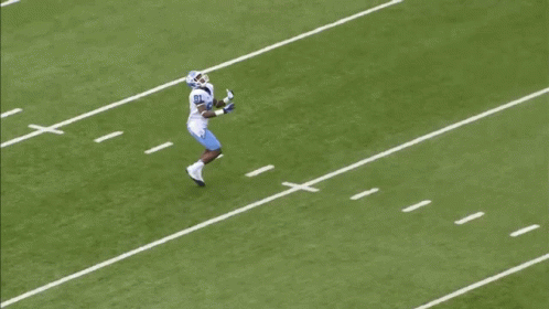 a football player is running across a field