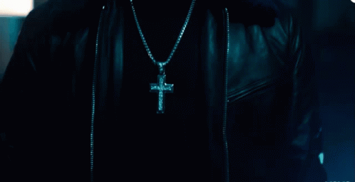 a person with a cross on a necklace
