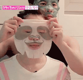 two people that are putting on different face masks