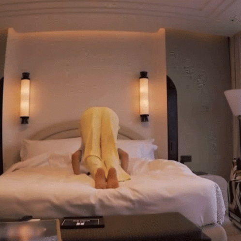 a bed with three lights on it with a person laying on the back