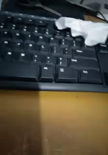 a crumpled piece of cloth is on top of a black keyboard