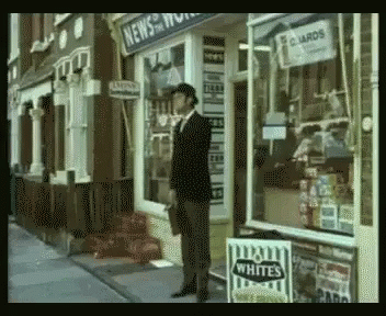 a man is standing outside of a store