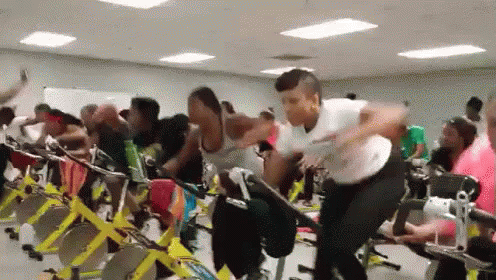 people exercising on stationary bikes in an office