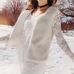a person is walking in the snow while dressed in white