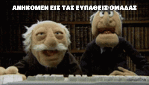 two animated puppets with long ears and beards sitting at a computer