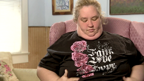 a woman in an oversize t - shirt with a floral design on her face
