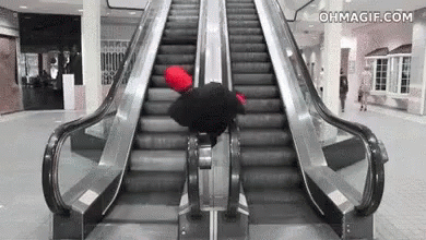 an escalator with people inside and two on it