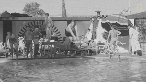 black and white pograph of people sitting on a float