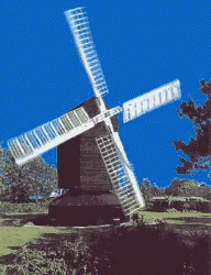 an artistic view of a windmill in the middle of a field