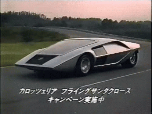 a futuristic car driving down a street on an outdoor track