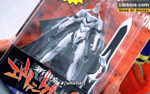 a toy figure in a plastic package with graffiti
